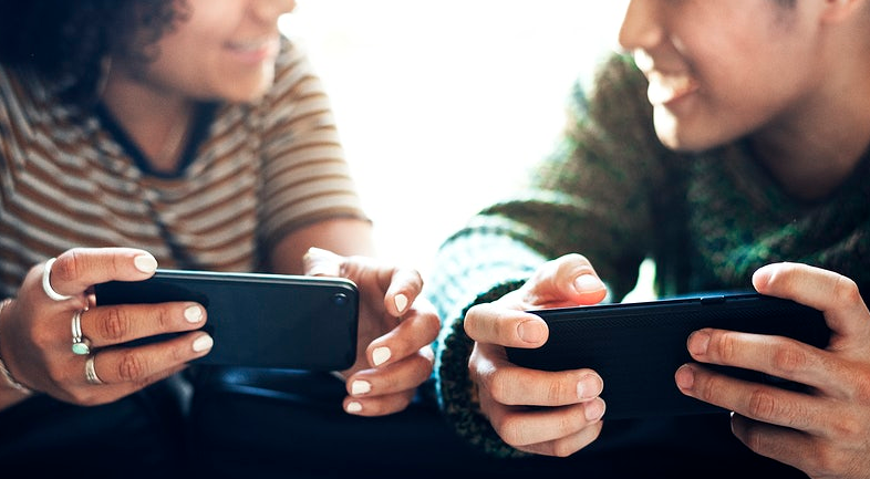 man and woman using phone